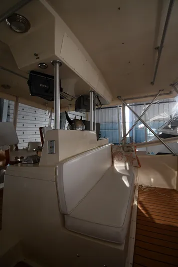 Stormy Yacht Photos Pics 1988 Viking 48 Convertible interior with seating and helm, showcasing classic design and functionality.