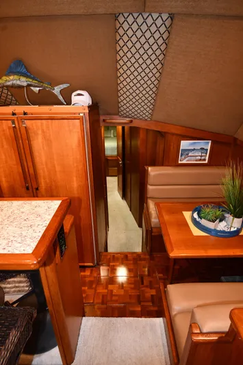 Stormy Yacht Photos Pics 1988 Viking 48 Convertible yacht interior with wood finish and dining area.