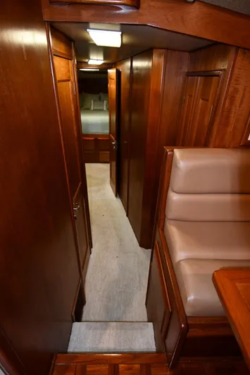 Stormy Yacht Photos Pics Interior hallway of 1988 Viking 48 Convertible yacht with wooden paneling and carpet.