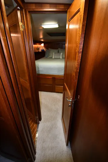 Stormy Yacht Photos Pics Interior of 1988 Viking 48 Convertible yacht, featuring a cozy bedroom with wooden finishes.