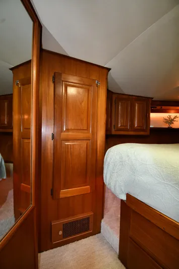 Stormy Yacht Photos Pics 1988 Viking 48 Convertible yacht interior with wooden cabinetry and cozy bedroom.
