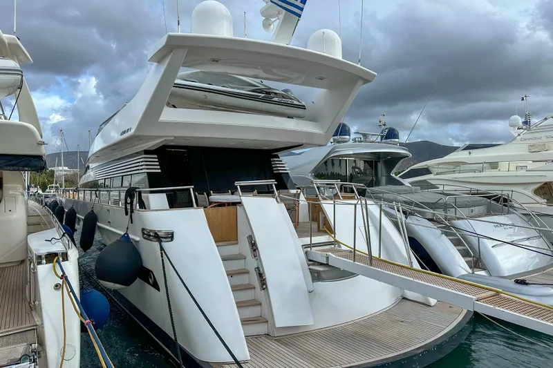 Galini Yacht Photos Pics Luxury yacht Cantieri di Pisa 27s, 2001 model, docked at marina under cloudy skies.