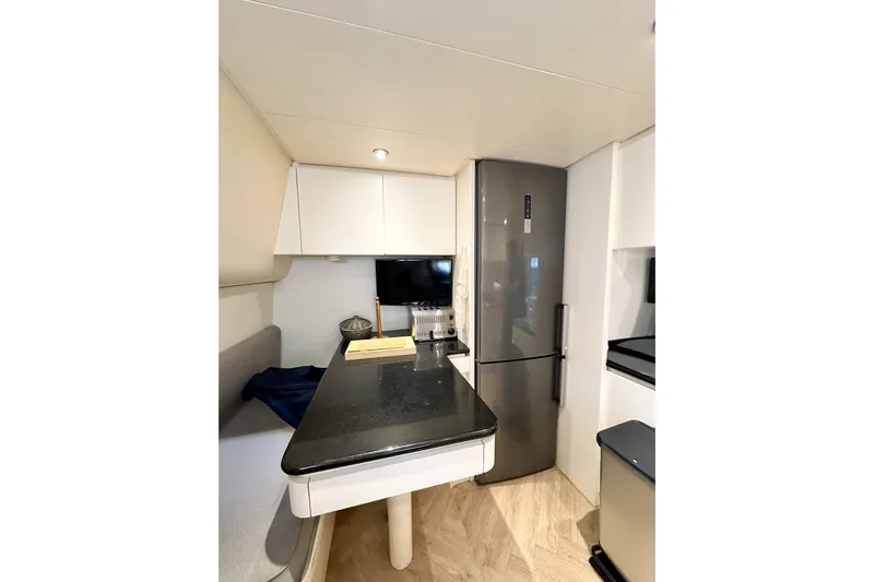 Galini Yacht Photos Pics Modern kitchen interior on 2001 Cantieri di Pisa 27s yacht, featuring sleek design and appliances.