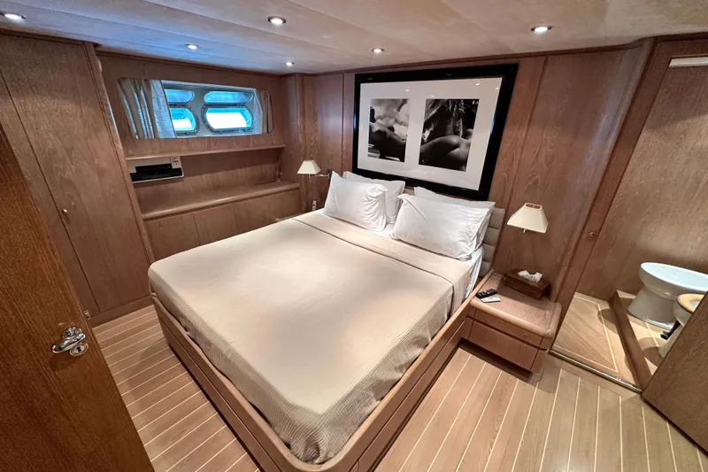 Galini Yacht Photos Pics Luxurious 2001 Cantieri di Pisa 27s yacht bedroom with elegant wood paneling and modern decor.