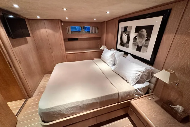 Galini Yacht Photos Pics Luxurious 2001 Cantieri di Pisa 27s yacht bedroom with elegant wood paneling and modern decor.