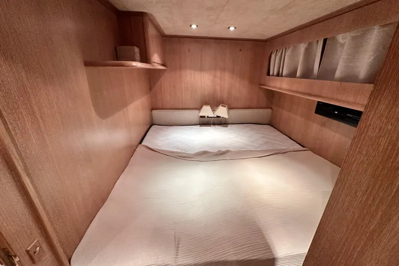 Galini Yacht Photos Pics Luxurious cabin interior of 2001 Cantieri di Pisa 27s yacht with cozy bedding.