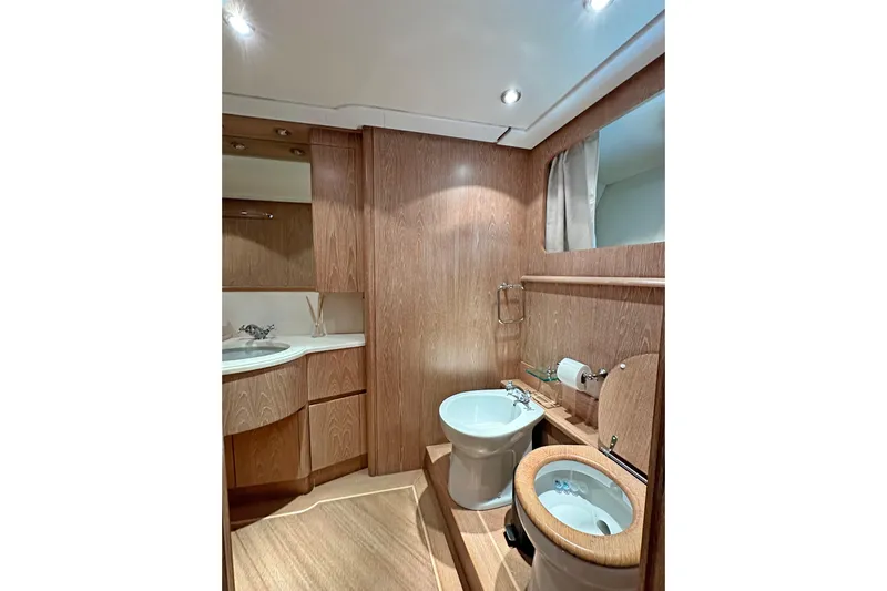 Galini Yacht Photos Pics Luxurious 2001 Cantieri di Pisa 27s yacht bathroom with wood accents and modern fixtures.
