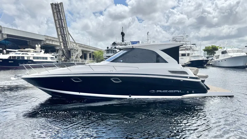 O-sea-d Yacht Photos Pics 2015 Regal 35 Sport Coupe yacht docked in marina, under cloudy sky.