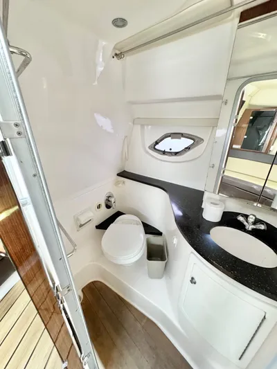 O-sea-d Yacht Photos Pics 2015 Regal 35 Sport Coupe bathroom with toilet, sink, and porthole window.