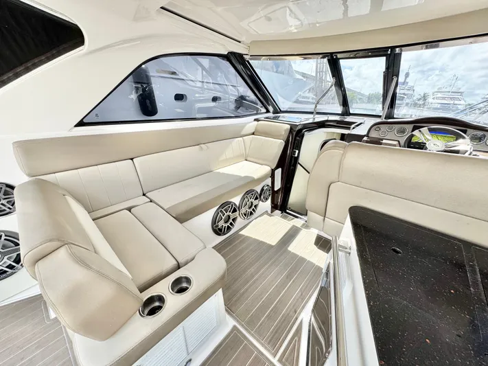 O-sea-d Yacht Photos Pics Interior of 2015 Regal 35 Sport Coupe with beige seating and modern dashboard.
