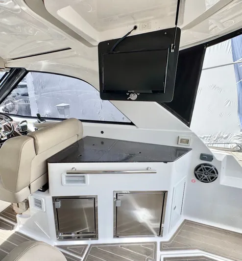 O-sea-d Yacht Photos Pics Interior of a 2015 Regal 35 Sport Coupe with TV and storage cabinets.