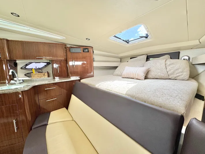 O-sea-d Yacht Photos Pics 2015 Regal 35 Sport Coupe interior with bed, kitchenette, and seating area.