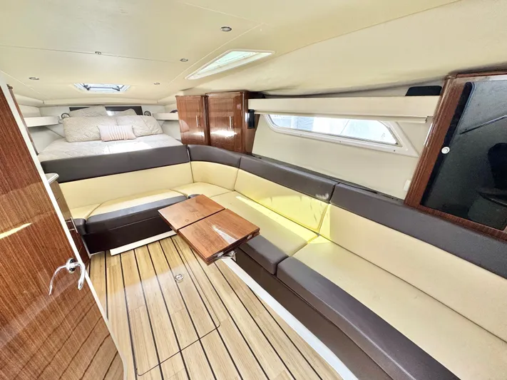 O-sea-d Yacht Photos Pics Luxurious interior of 2015 Regal 35 Sport Coupe with elegant seating and wooden accents.
