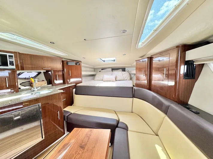 O-sea-d Yacht Photos Pics Luxurious interior of 2015 Regal 35 Sport Coupe with modern kitchen and cozy seating.