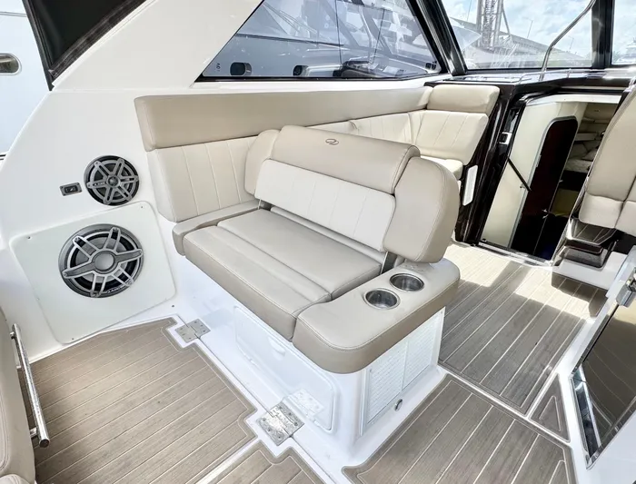 O-sea-d Yacht Photos Pics 2015 Regal 35 Sport Coupe interior with beige seating and cup holders.