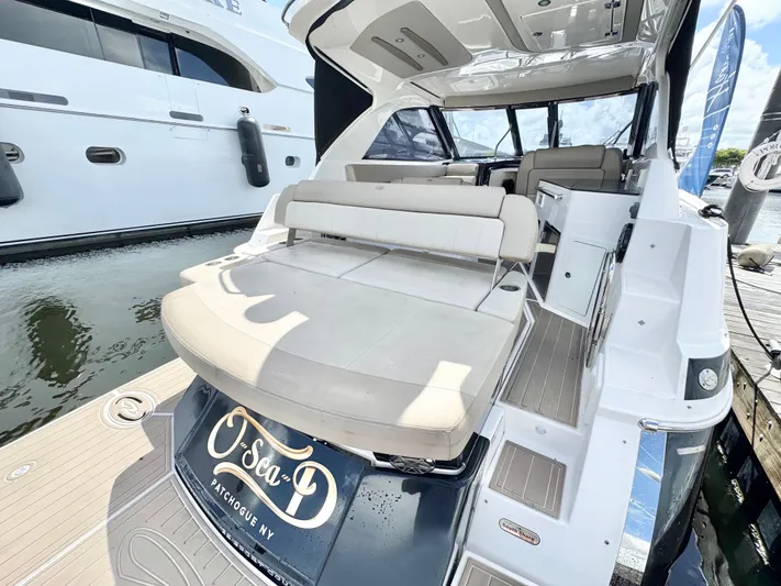 O-sea-d Yacht Photos Pics 2015 Regal 35 Sport Coupe yacht with spacious seating and sleek design at a marina.