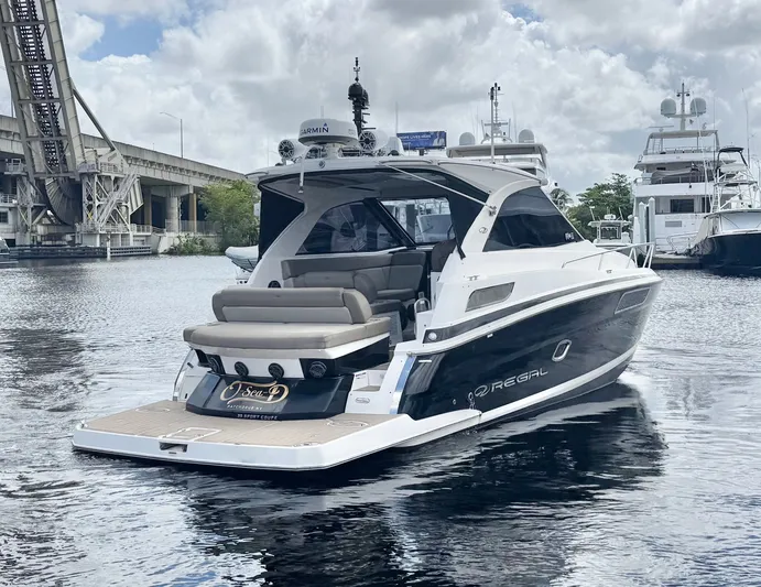 O-sea-d Yacht Photos Pics 2015 Regal 35 Sport Coupe yacht docked near a bridge on a cloudy day.