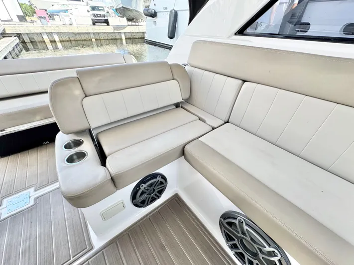 O-sea-d Yacht Photos Pics 2015 Regal 35 Sport Coupe interior seating with cup holders and speakers.