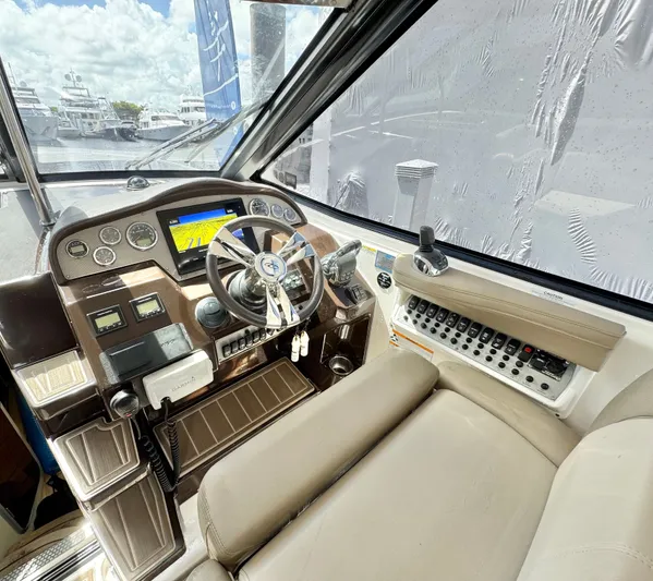 O-sea-d Yacht Photos Pics Cockpit of 2015 Regal 35 Sport Coupe with steering wheel and control panel.