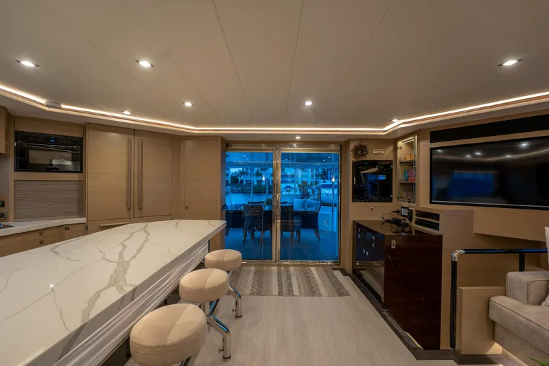 Fruition Yacht Photos Pics Luxurious interior of 2020 Horizon PC60 yacht with modern kitchen and seating area.