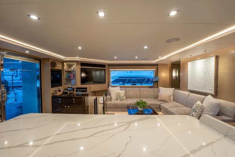 Fruition Yacht Photos Pics Luxurious interior of 2020 Horizon PC60 yacht with modern decor and spacious seating area.