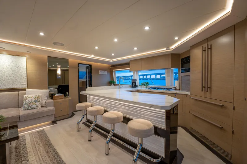 Fruition Yacht Photos Pics Luxurious interior of 2020 Horizon PC60 yacht with modern kitchen and seating area.
