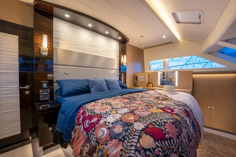Fruition Yacht Photos Pics Luxurious bedroom interior on 2020 Horizon PC60 yacht with floral bedding and modern lighting.