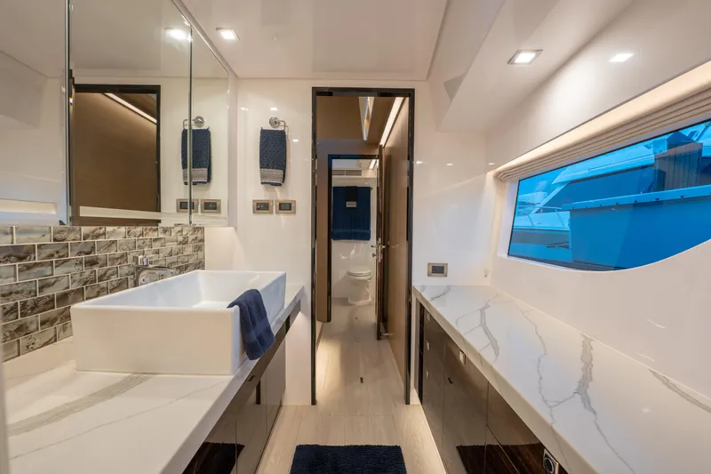 Fruition Yacht Photos Pics Luxurious Horizon PC60 yacht bathroom with modern fixtures and large window, 2020 model.