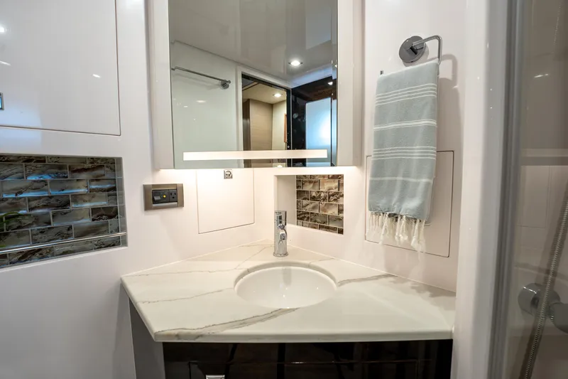 Fruition Yacht Photos Pics Modern bathroom vanity in Horizon PC60, 2020 model, with marble countertop and elegant fixtures.