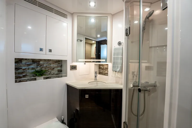 Fruition Yacht Photos Pics Luxurious bathroom in 2020 Horizon PC60 yacht with modern fixtures and glass shower.