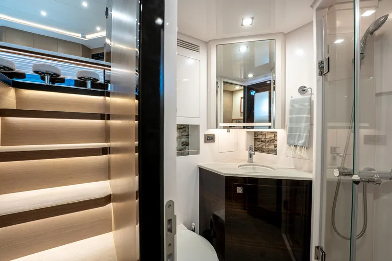 Fruition Yacht Photos Pics Luxurious Horizon PC60 yacht interior with modern bathroom and illuminated staircase, 2020 model.