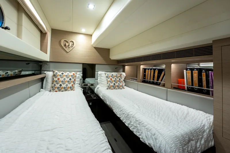 Fruition Yacht Photos Pics Luxurious twin cabin in 2020 Horizon PC60 yacht with modern decor and cozy bedding.
