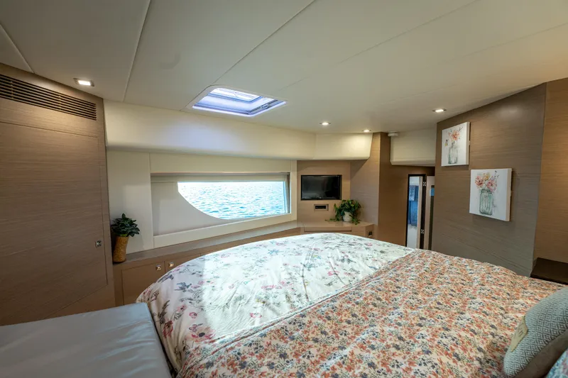 Fruition Yacht Photos Pics Luxurious bedroom interior of 2020 Horizon PC60 yacht with floral bedding and ocean view.