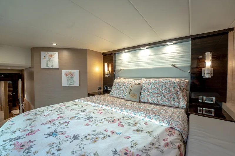 Fruition Yacht Photos Pics Luxurious bedroom interior on 2020 Horizon PC60 yacht with floral bedding and modern lighting.