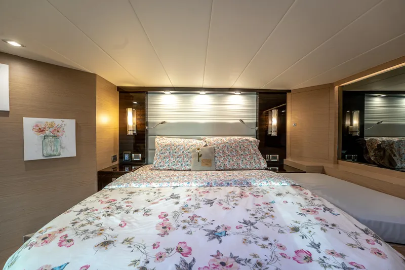 Fruition Yacht Photos Pics Luxurious bedroom interior on 2020 Horizon PC60 yacht with floral bedding and elegant lighting.