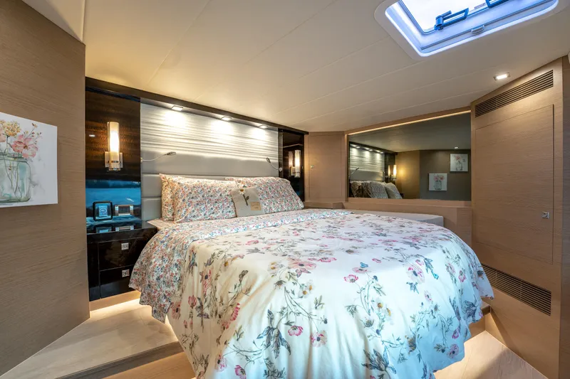 Fruition Yacht Photos Pics Luxurious bedroom interior on 2020 Horizon PC60 yacht with floral bedding and modern lighting.
