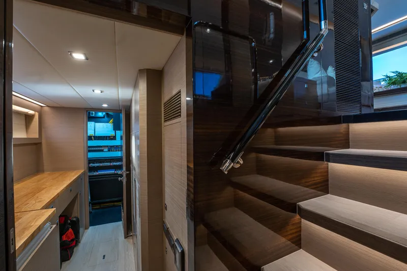 Fruition Yacht Photos Pics Luxurious interior of 2020 Horizon PC60 yacht with modern staircase and sleek design.