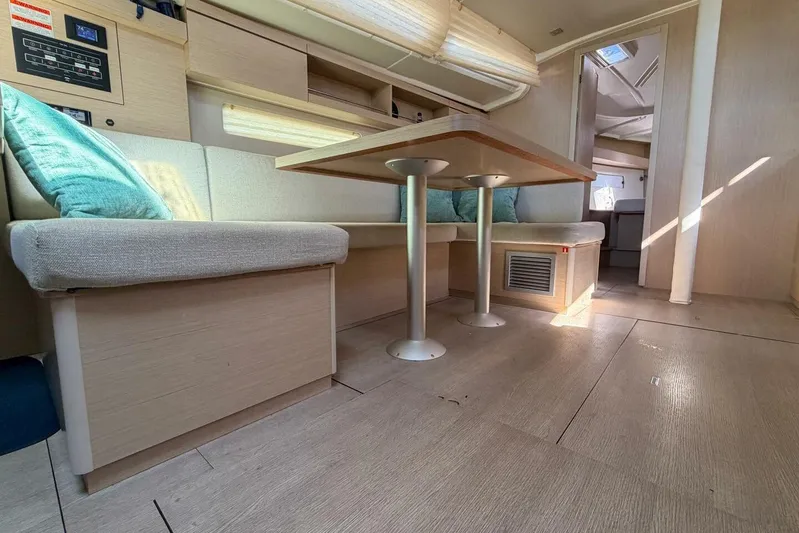 Happy Ours Yacht Photos Pics Interior of 2022 Beneteau Oceanis 40.1 yacht with modern seating and dining area.