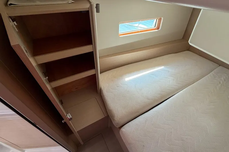 Happy Ours Yacht Photos Pics 2022 Beneteau Oceanis 40.1 cabin interior with twin beds and storage shelves.