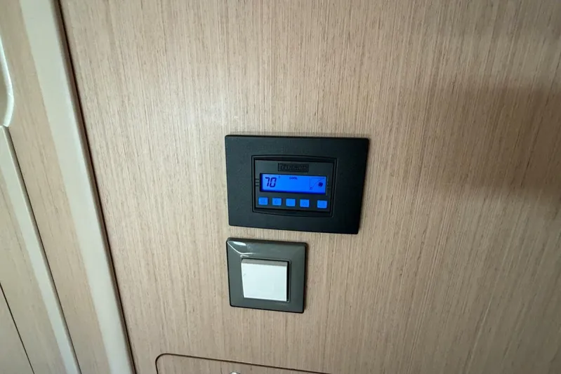 Happy Ours Yacht Photos Pics Thermostat and switch on Beneteau Oceanis 40.1 yacht, 2022 model, wooden interior panel.