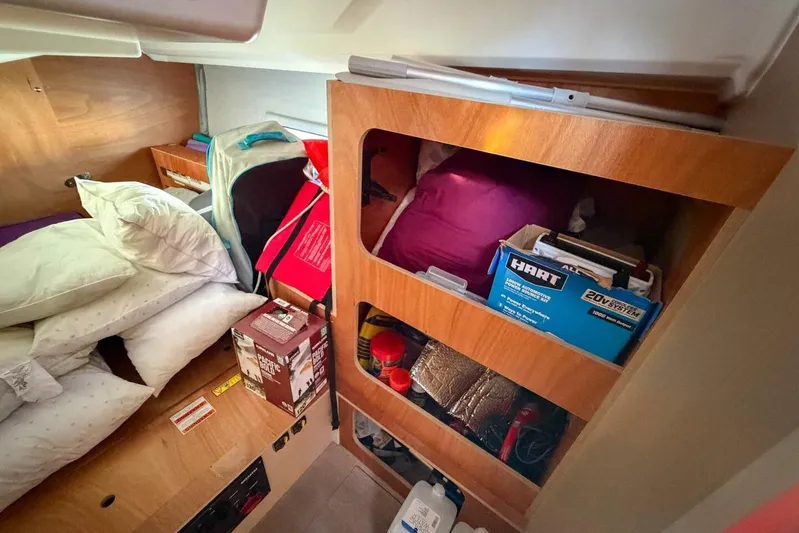 Happy Ours Yacht Photos Pics Interior cabin storage of 2022 Beneteau Oceanis 40.1 yacht, featuring shelves and bedding.