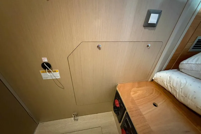 Happy Ours Yacht Photos Pics Interior cabin of 2022 Beneteau Oceanis 40.1 yacht, featuring wooden paneling and storage.