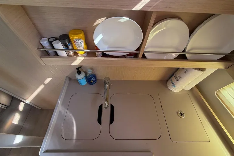 Happy Ours Yacht Photos Pics Modern kitchen area in 2022 Beneteau Oceanis 40.1 yacht with sink and storage.