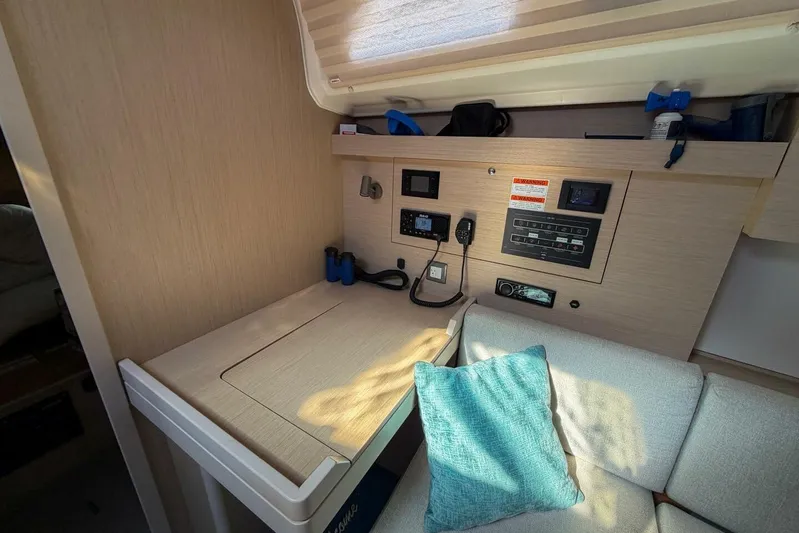 Happy Ours Yacht Photos Pics Interior of 2022 Beneteau Oceanis 40.1 yacht with navigation station and seating area.