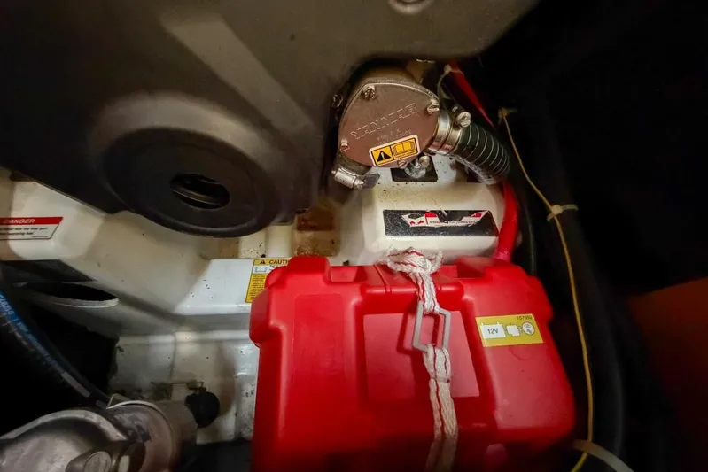 Happy Ours Yacht Photos Pics Engine compartment of 2022 Beneteau Oceanis 40.1 with red battery box and mechanical components.