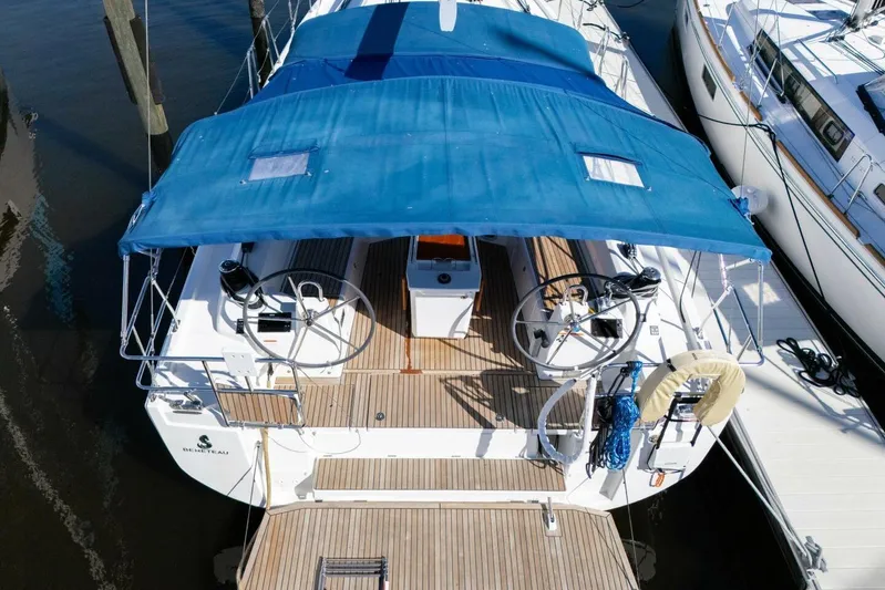 Happy Ours Yacht Photos Pics 2022 Beneteau Oceanis 40.1 sailboat with blue canopy, docked at marina.