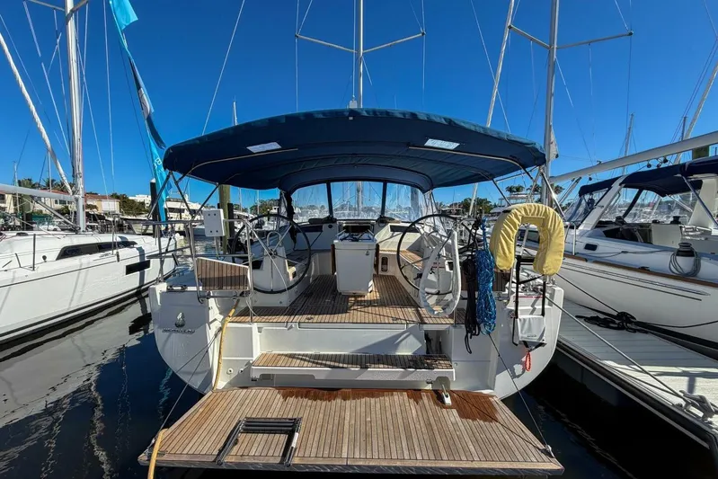 Happy Ours Yacht Photos Pics 2022 Beneteau Oceanis 40.1 sailboat docked at marina, rear view.