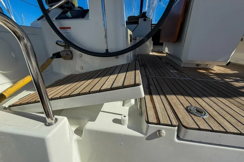 Happy Ours Yacht Photos Pics Cockpit of 2022 Beneteau Oceanis 40.1 sailboat with teak flooring and steering wheel.