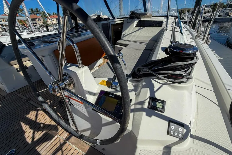 Happy Ours Yacht Photos Pics Cockpit view of 2022 Beneteau Oceanis 40.1 sailboat, featuring steering wheel and navigation instruments.