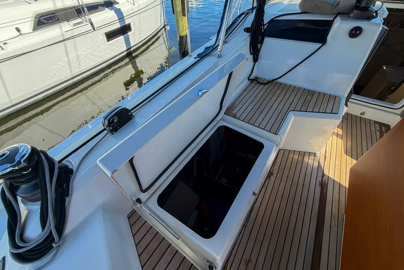 Happy Ours Yacht Photos Pics 2022 Beneteau Oceanis 40.1 yacht cockpit with open storage compartment and teak flooring.